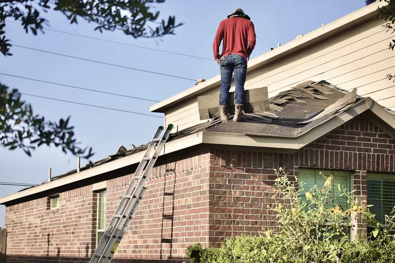 Professional roofer working on a residential roof in Lewisville